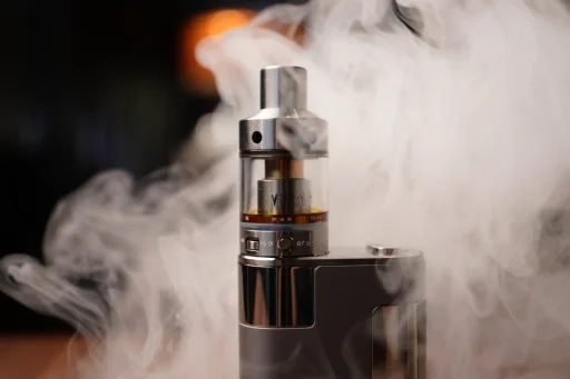 Close up of vape devices with e-liquids like blueberry ice vape and grape ice vape.